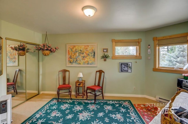 living area with light colored carpet and a baseboard radiator