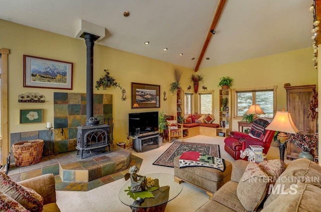 living room featuring vaulted ceiling with beams and a wood stove