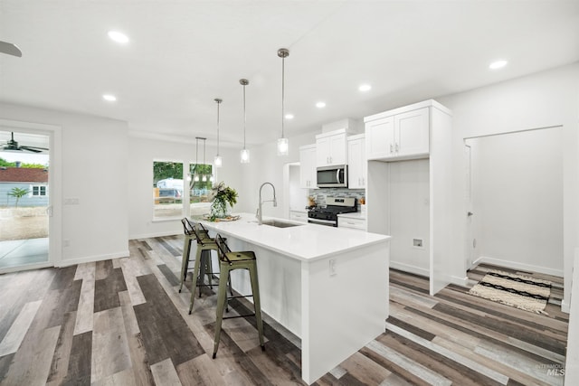 kitchen featuring a wealth of natural light, backsplash, stainless steel appliances, and a sink