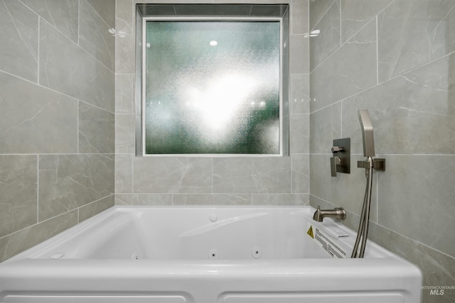 bathroom featuring tile walls and a jetted tub