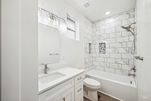 full bathroom featuring visible vents, shower / bathtub combination, toilet, and vanity