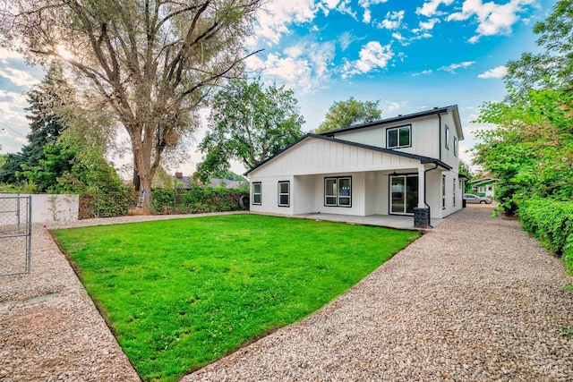 back of house featuring a yard and fence