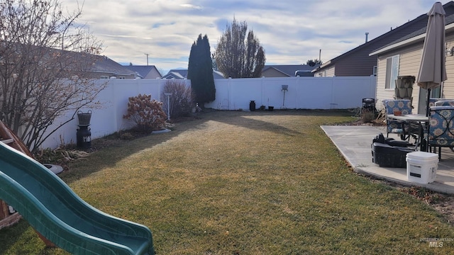 view of yard with a patio area and a playground