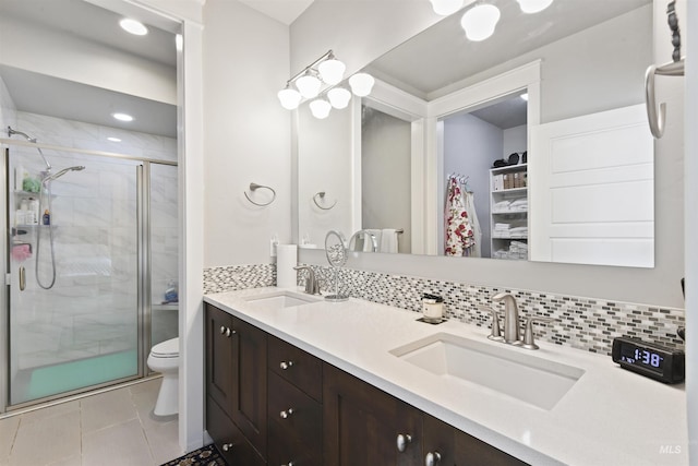 6164 N Winward Ln, Meridian, ID 83646 - full bathroom with toilet, double vanity, a shower stall, backsplash, and tile patterned floors