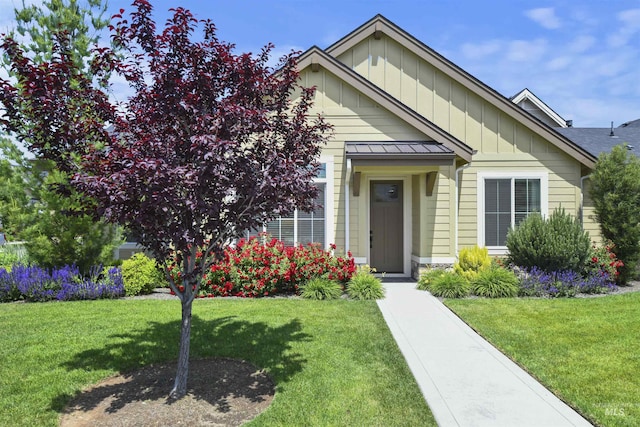 6164 N Winward Ln, Meridian, ID 83646 - view of front of property featuring a standing seam roof, board and batten siding, a front lawn, and metal roof