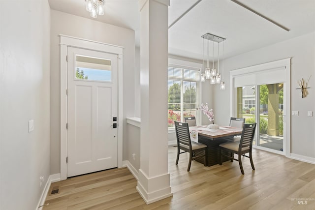 6164 N Winward Ln, Meridian, ID 83646 - dining space with a chandelier, light wood-type flooring, and baseboards