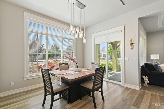 6164 N Winward Ln, Meridian, ID 83646 - dining room with light wood-style flooring, baseboards, and a chandelier