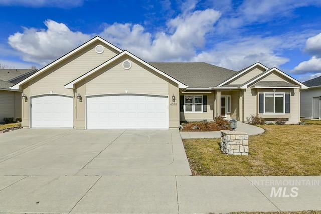 view of front facade with a garage, driveway, and a front lawn