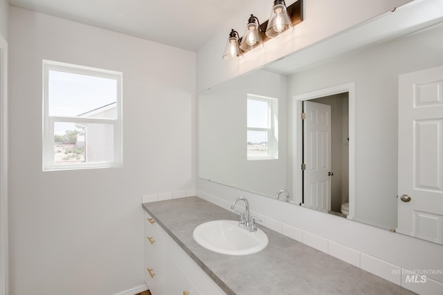 bathroom featuring vanity and toilet