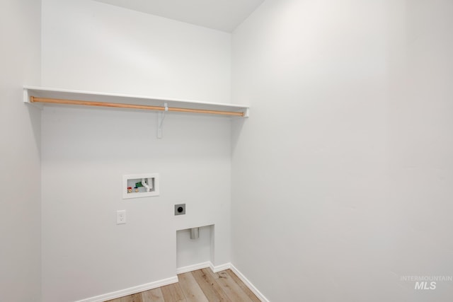 laundry area featuring hookup for an electric dryer, hookup for a washing machine, and light hardwood / wood-style flooring