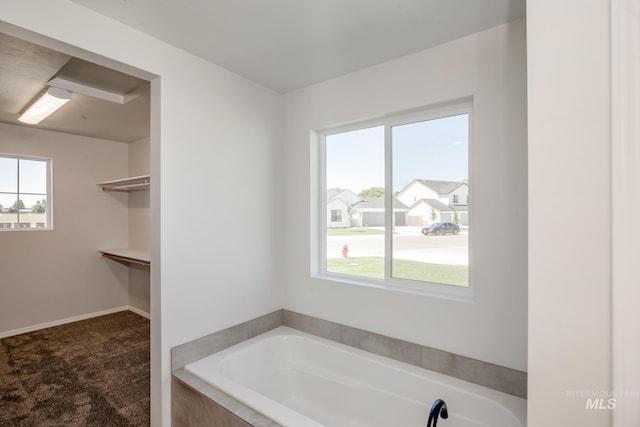 bathroom with tiled bath