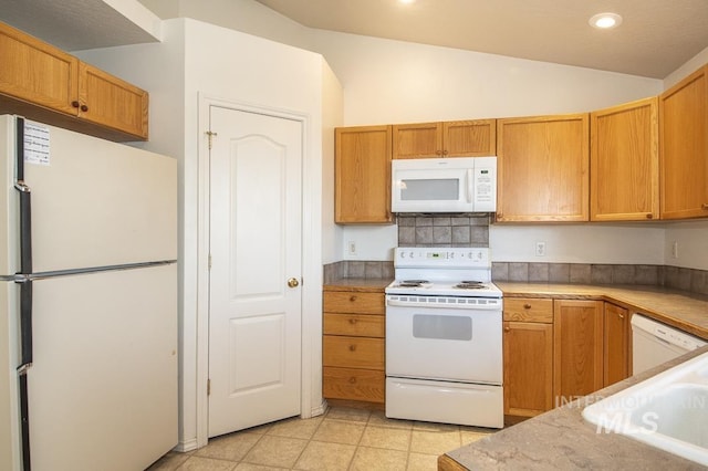 kitchen featuring white appliances, light tile patterned floors, lofted ceiling, recessed lighting, and light countertops