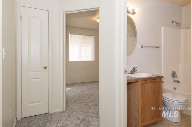 bathroom with toilet, vanity, and shower / tub combination