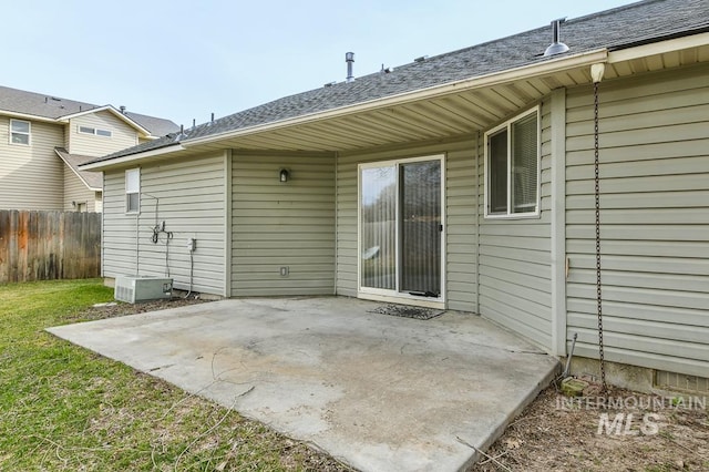 back of property with a patio area, a yard, and fence