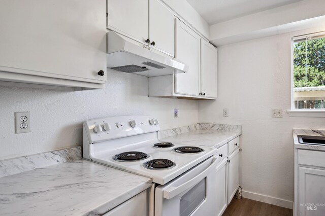 228 N Latah St, Boise, ID 83706 - kitchen with white range with electric stovetop, under cabinet range hood, dark wood-style flooring, and light countertops