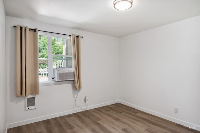 228 N Latah St, Boise, ID 83706 - unfurnished room featuring wood finished floors, cooling unit, and heating unit