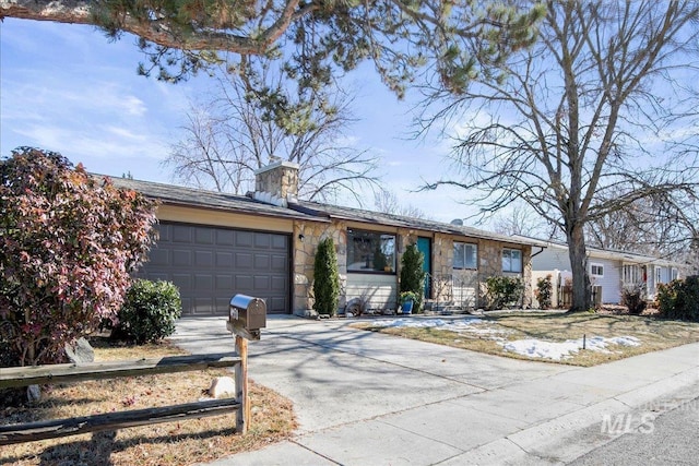 ranch-style home featuring stone siding, a chimney, an attached garage, and driveway