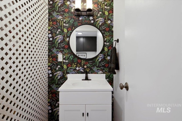 bathroom featuring vanity and wallpapered walls