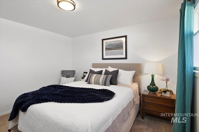 bedroom featuring a textured ceiling and carpet