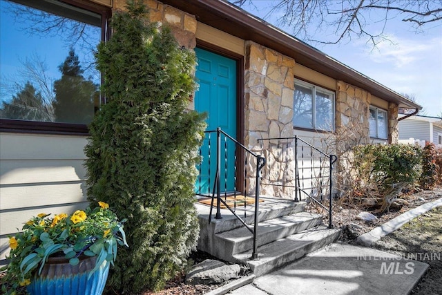 entrance to property with stone siding