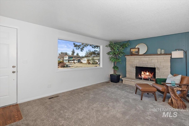 sitting room featuring visible vents, a textured ceiling, and carpet flooring