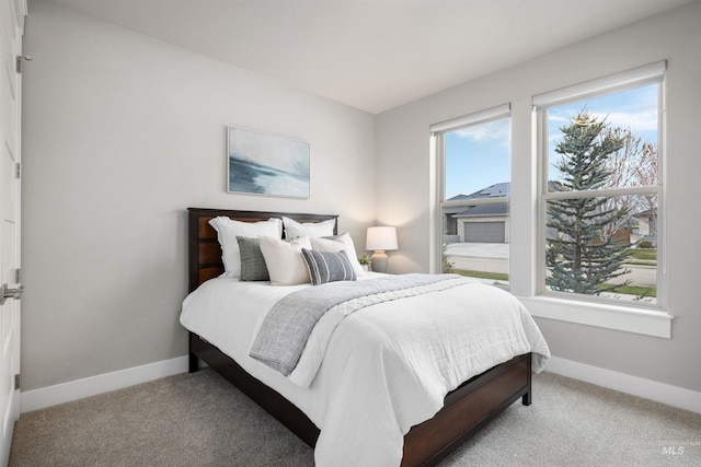 bedroom with baseboards and carpet