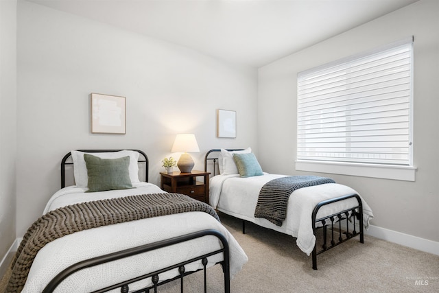 bedroom with baseboards and carpet