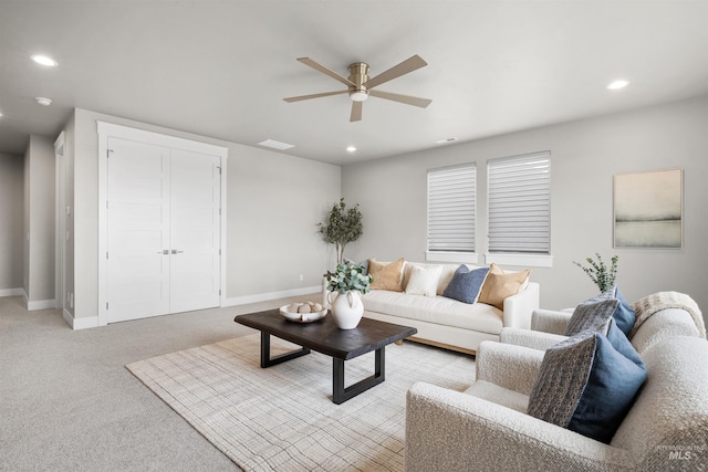 living area featuring a ceiling fan, light carpet, baseboards, and recessed lighting