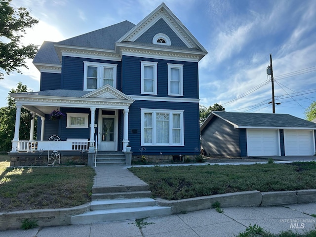 411 W 3rd St, Weiser, ID 83672 - view of front of property featuring a porch, a detached garage, an outdoor structure, and a front yard