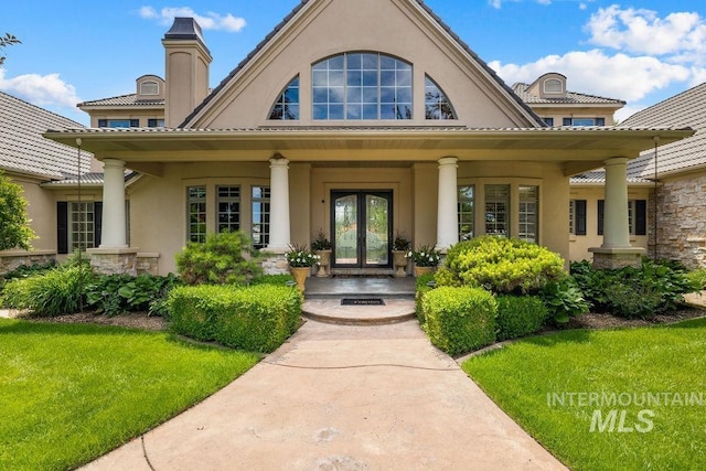 4119 N Park Ln, Eagle, ID 83616 - property entrance featuring french doors, stucco siding, a porch, a yard, and stone siding