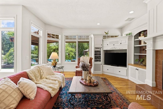 4119 N Park Ln, Eagle, ID 83616 - living room with light wood-type flooring, recessed lighting, and a textured ceiling