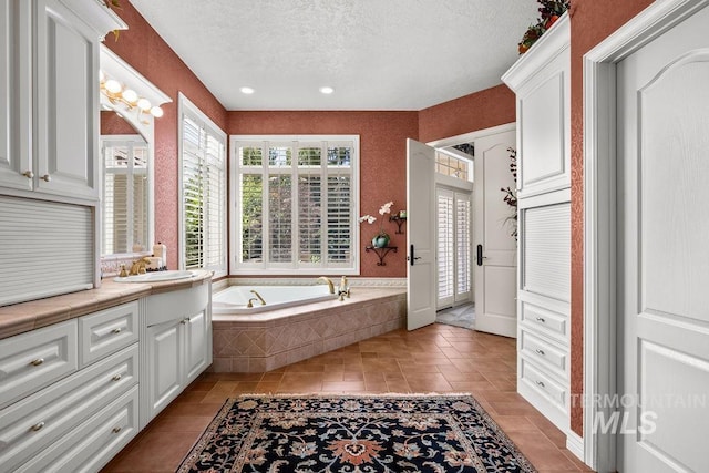 4119 N Park Ln, Eagle, ID 83616 - full bathroom with plenty of natural light, vanity, a textured ceiling, a bath, and tile patterned floors