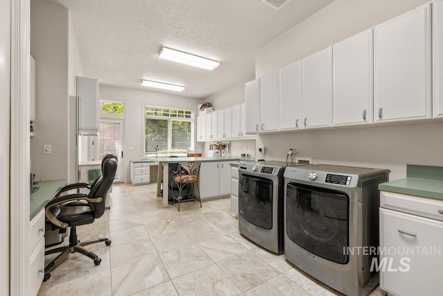 4119 N Park Ln, Eagle, ID 83616 - laundry area featuring washing machine and dryer, cabinet space, an office area, a textured ceiling, and light tile patterned floors
