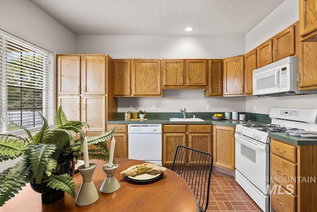 4119 N Park Ln, Eagle, ID 83616 - kitchen featuring white appliances, brick patterned floors, dark countertops, recessed lighting, and brown cabinets