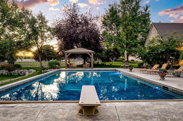 4119 N Park Ln, Eagle, ID 83616 - pool at dusk with a diving board, a patio, and a gazebo