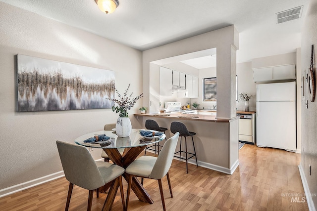 dining space featuring light hardwood / wood-style flooring