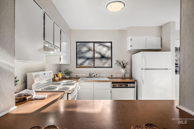 kitchen featuring white cabinetry, sink, and white appliances