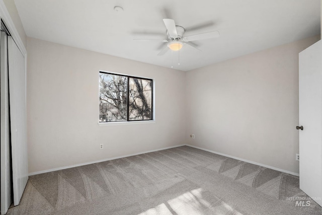 unfurnished bedroom featuring ceiling fan, carpet floors, and a closet