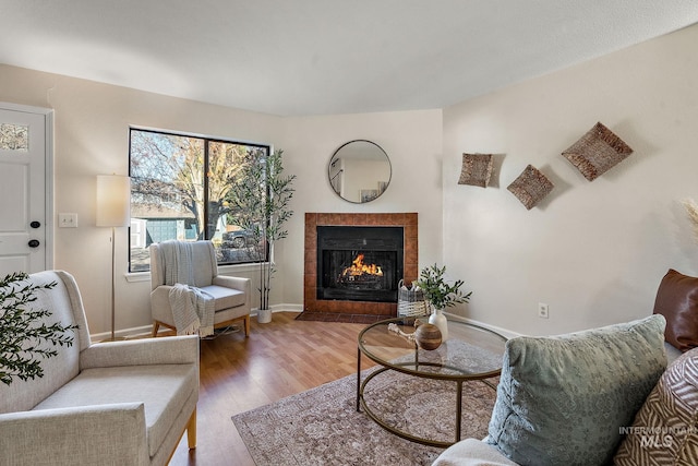 living room featuring hardwood / wood-style flooring and a tile fireplace