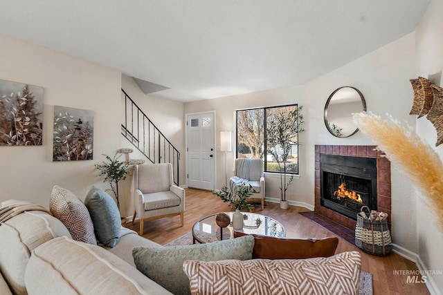 living room with a fireplace and hardwood / wood-style flooring