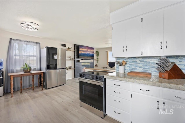 kitchen with white cabinetry, light wood finished floors, backsplash, and appliances with stainless steel finishes