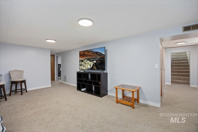 sitting room featuring visible vents, stairway, baseboards, and carpet