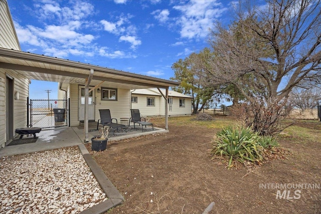view of yard with a patio, a gate, and fence