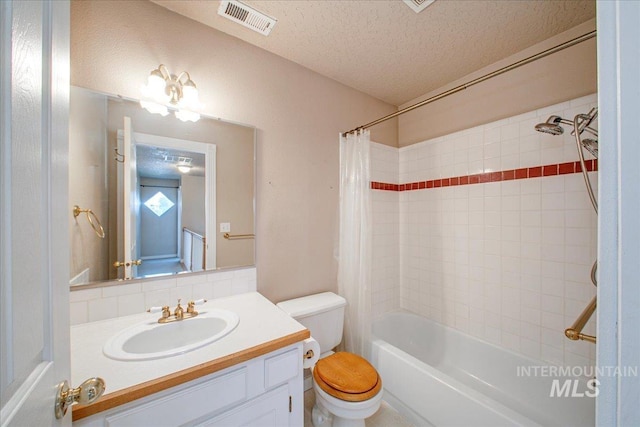 1239 Willow Creek Dr, Nampa, ID 83686 - bathroom featuring a textured ceiling, toilet, vanity, and shower / bathtub combination with curtain