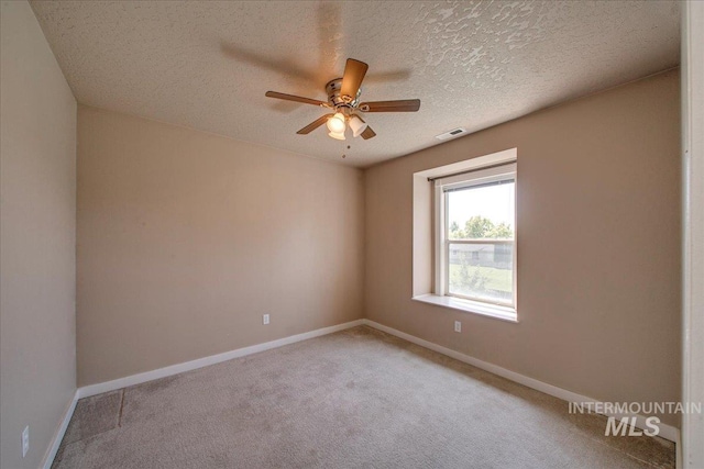 1239 Willow Creek Dr, Nampa, ID 83686 - unfurnished room with ceiling fan, light carpet, baseboards, and a textured ceiling