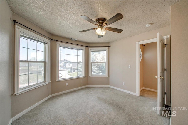 1239 Willow Creek Dr, Nampa, ID 83686 - spare room featuring ceiling fan, light carpet, a textured ceiling, and baseboards