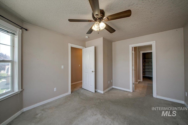 1239 Willow Creek Dr, Nampa, ID 83686 - unfurnished bedroom with a textured ceiling, carpet, baseboards, and a ceiling fan
