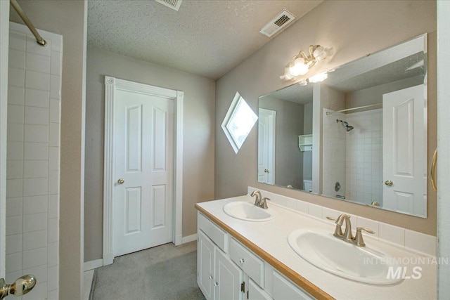 1239 Willow Creek Dr, Nampa, ID 83686 - bathroom with double vanity, toilet, a shower, a textured ceiling, and baseboards