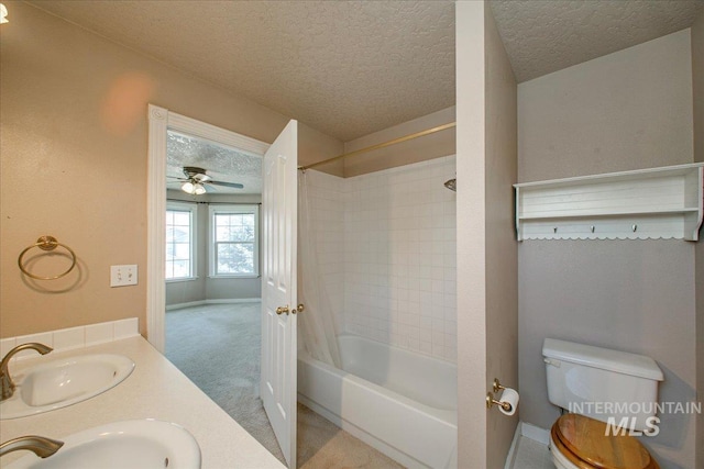 1239 Willow Creek Dr, Nampa, ID 83686 - bathroom featuring shower / tub combination, toilet, a textured ceiling, double vanity, and ceiling fan