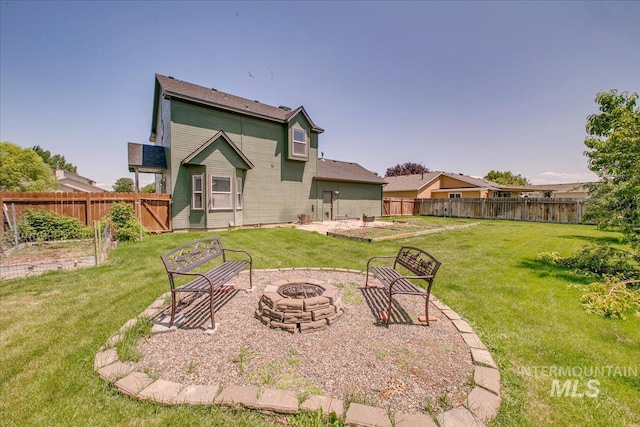 1239 Willow Creek Dr, Nampa, ID 83686 - rear view of property featuring an outdoor fire pit and a vegetable garden